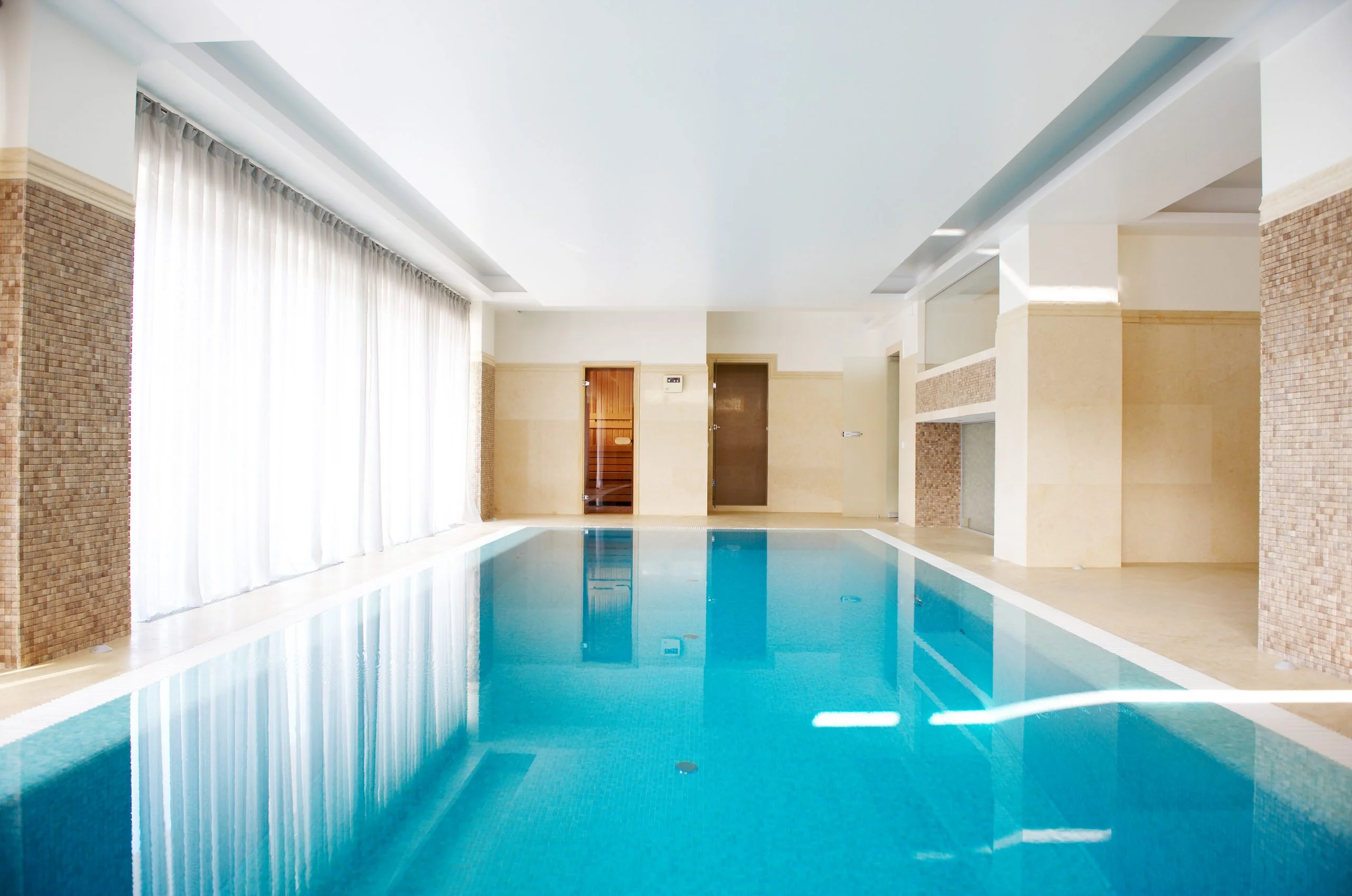 a indoor swimming pool with a large window